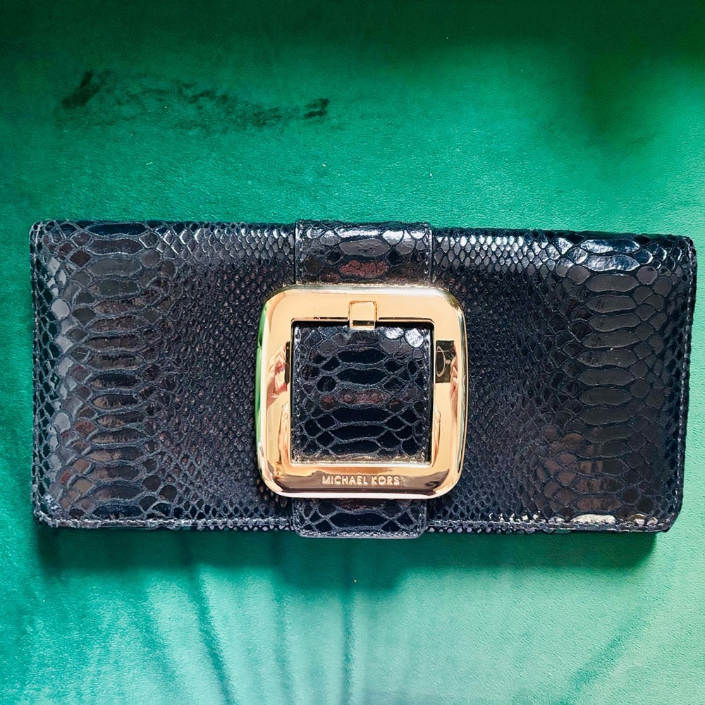 Michael Kors black and gold clutch bag.